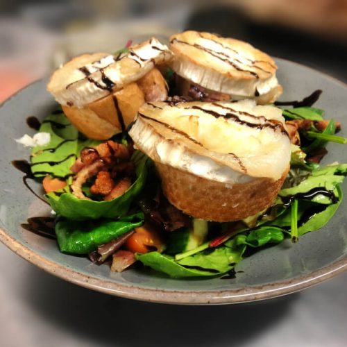 Seasonal salad with four slices of baguette and rounds of soft cheese. Drizzled balsamic vinegar glaze over the top. Burton Farm, Local Farm shop, Chippenham.