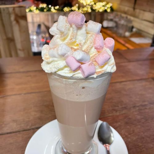 Luxury Hot Chocolate; Big Latte glass with Whipped cream built on top with pink and white mini marshmallows. Burton Farm, Local Farm shop, Chippenham.